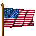 Picture of United States flag flying on flag pole blowing in the wind