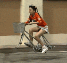 Funny girl riding a bicycle so fast the wheels totally disappear gif animation