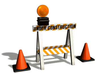 Under construction caution barricade with flashing light and traffic cones