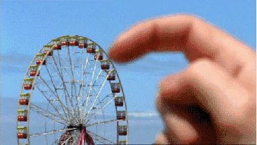 Cinemagraph of a giant finger pushing a miniature Farris Wheel around (Pretend)