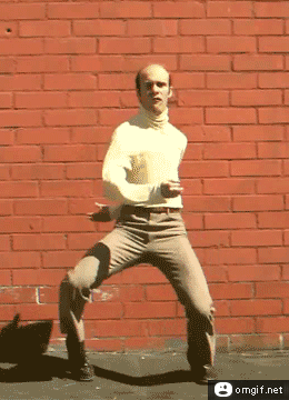 Animation of man in yellow shirt and brown pants doing a crazy dance flailing his arms about and wobbling his legs wildly  as he dances. Dancin' fool, Rubber band man . . .