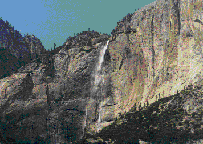 Waterfall high in a mountain with water plunging hundreds of feet to the ground below