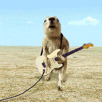 Prairie dog playing electric guitar out on the prairie