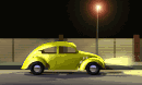 Yellow Volkswagen Bug moving on the road under the lights at night